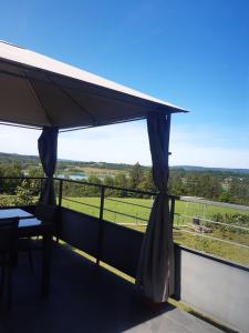 a balcony with a view of a field at Gîte les Griffons in Clairvaux-les-Lacs +3 photos