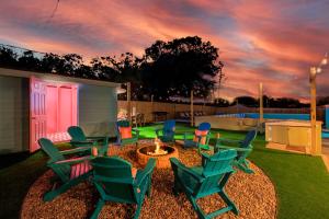 a group of chairs sitting around a fire pit at Private Pool 6 MI to Clearwater Beach Fire Pit Game Room in Clearwater