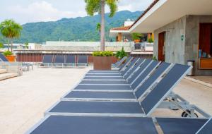 a row of blue benches on a patio at Penthouse Studio 2 blocks from Los Muertos beach in Puerto Vallarta