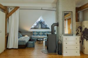 a living room with a couch and a mirror at arte vida in Salzburg