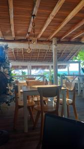 a dining room with tables and chairs in a restaurant at Cristal Blue Barú in Baru