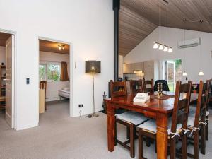 a dining room with a wooden table and chairs at 5 person holiday home in Bording-By Traum in Bording Stationsby +17 photos