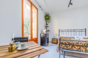 a bedroom with a bed and a wooden table at Villa Gatta in Rome