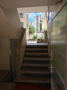 a stairway in a building with stairs leading into a building at Praiamongagua in Mongaguá