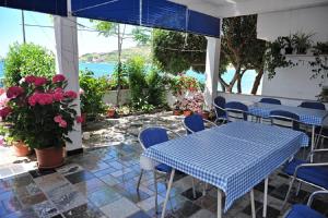 a room with a table and chairs and flowers at Apartments Draga in Metajna