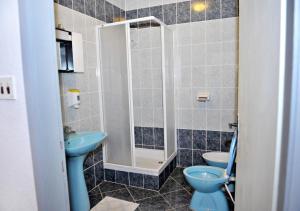 a bathroom with two blue toilets and a sink at Apartments Draga in Metajna +35 photos
