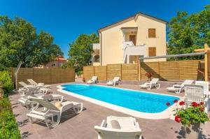 una villa con piscina y una casa en Apartment Marinko, en Barban