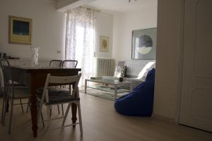 a living room with a table and a couch at La Signora Dei Fiori in Gubbio +32 photos