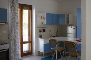 a kitchen with blue cabinets and a white counter top at La Signora Dei Fiori in Gubbio