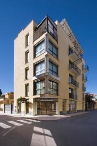 a tall building on the corner of a street at Residenza Serenella in Diano Marina