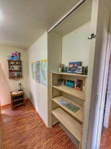 a hallway with wooden shelves in a room at Casa Natales - Dormitorio Privado in Puerto Natales