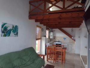 a living room with a table and a kitchen at HUAYCAMAR in Playa Dorada