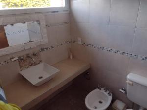 a small bathroom with a sink and a toilet at HUAYCAMAR in Playa Dorada +17 photos