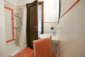 a bathroom with a sink and a tub and a shower at C dra Topia the Grape Pergola House near Alba Charming house - Italy in Trezzo Tinella