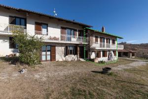 a large house with a yard in front of it at C dra Topia the Grape Pergola House near Alba Charming house - Italy in Trezzo Tinella