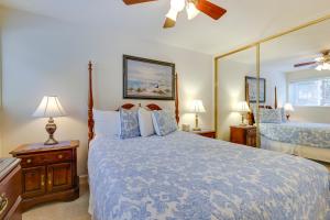 a bedroom with a large bed and a mirror at Cozy Oregon Resort Condo - Steps to Lincoln Beach! in Lincoln City +19 photos