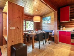 a dining room with a table and black chairs at Im Brixenthal I in Wörgl +17 photos