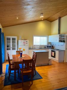 a kitchen and dining room with a table and chairs at Banksia Views in Sandy Point