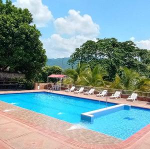 a large swimming pool with chairs and a table at LOMA LINDA Hotel de Naturaleza in La Mesa +41 photos