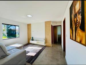 a living room with a couch and a window at Casa Atantida Sul in Osório