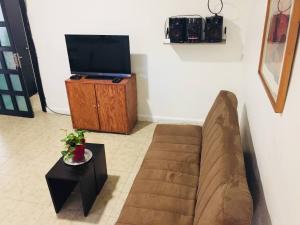 a living room with a couch and a tv at Department, Studio Type Excellent Location in Mexico City