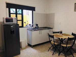 a small kitchen with a table and a microwave at Department, Studio Type Excellent Location in Mexico City