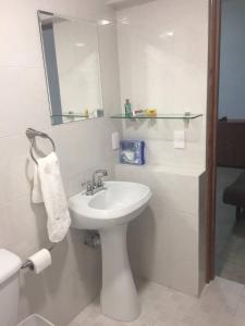 a white bathroom with a sink and a mirror at Department, Studio Type Excellent Location in Mexico City
