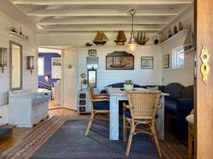 a dining room with a table and chairs at 6 pers House Marijke with winter garden and direct access to the Lauwersmeer in Anjum