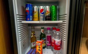 a refrigerator filled with lots of drinks and sodas at Sangam Resort, pilani in Chirāwa