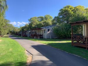 a row of mobile homes on the side of a road at Four Seasons Holiday Park in Marybrook