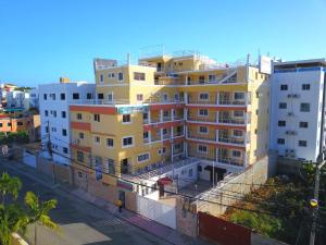 a large yellow building on the side of a street at Double Room 2 Beds with Terrace in Corales del Sur - Las Americas Airport in La Viva