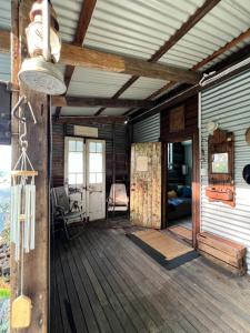 a porch of a house with a wooden deck at The Cabin, Ghost Gum Gully in Thornton