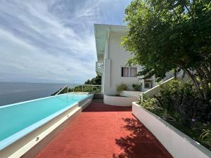a view of a house with a swimming pool at Assaly Villa - Breathtaking Ocean View with private beach in San Jose