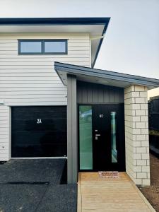 a house with a garage with the number at New Built Gem in Hillcrest in Hamilton