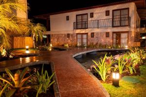 a resort with a pond in front of a building at Diamantino Residence - apt 07 CalmariaMucuge in Mucugê
