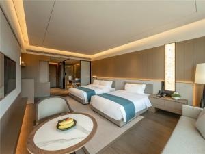 Postel nebo postele na pokoji v ubytování Yibo Jinling Hotel Moganshan