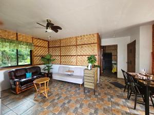 a living room with a couch and a table at Siquijor Cottage Lynn with Solar System in Maria