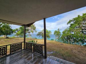 a view of the ocean from the porch of a house at Siquijor Cottage Lynn with Solar System in Maria