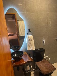 a bathroom with a sink and a mirror and a toilet at Casa AL Mar - Praia do Preá in Prea +46 photos