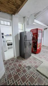 an empty room with a refrigerator and a magazine at Casa Martín in Bogotá