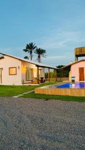 a house with a driveway and a house at Sol de Corumbau in Corumbau