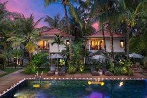 a house with a swimming pool in front of a house at Apsara Greenland Boutique Villa & Resort in Siem Reap
