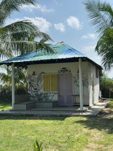 a small house with a painting on the side of it at PointBreak Resort in Kalpitiya