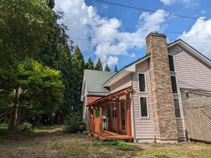 a small house with a brick chimney on top at Pension Ciffon in Kitakami