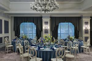 a dining room with blue tables and chairs and a chandelier at Renaissance Austin Arboretum Domain Hotel in Austin +121 photos