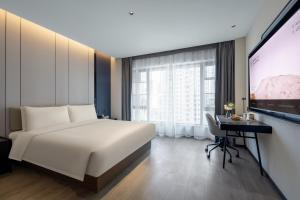 Voodi või voodid majutusasutuse Atour Hotel Changsha Middle Furong Road Tujiachong toas