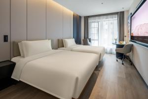 Voodi või voodid majutusasutuse Atour Hotel Changsha Middle Furong Road Tujiachong toas