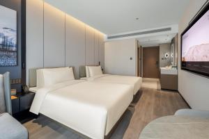 Voodi või voodid majutusasutuse Atour Hotel Changsha Middle Furong Road Tujiachong toas