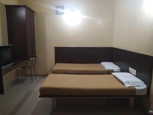Postel nebo postele na pokoji v ubytování chiranthlodge