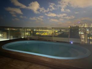 a hot tub on the roof of a building at Tambaú Beach apartment in João Pessoa